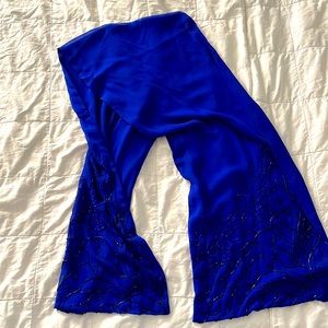 Rich silky royal blue 64” x 12” scarf with sparkly beads at each end of scarf.